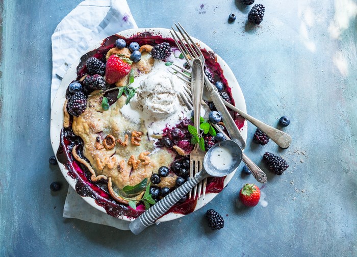 Berry pie with ice cream and forks