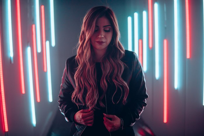 Woman in black jacket with neon lights