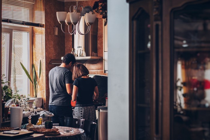Couple cooking breakfast in a kitchen