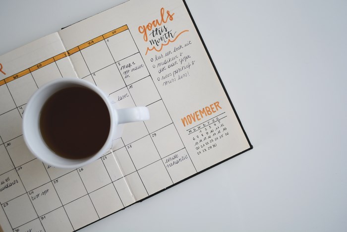 Bullet journal with November calendar and coffee