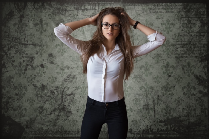 Woman with long brown hair and glasses