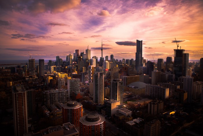 Toronto skyline at sunset with purple and orange clouds