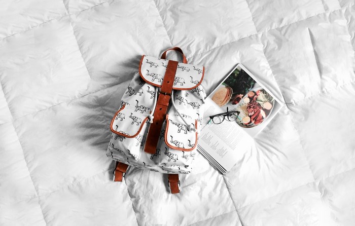 Backpack with elephant pattern on a white duvet