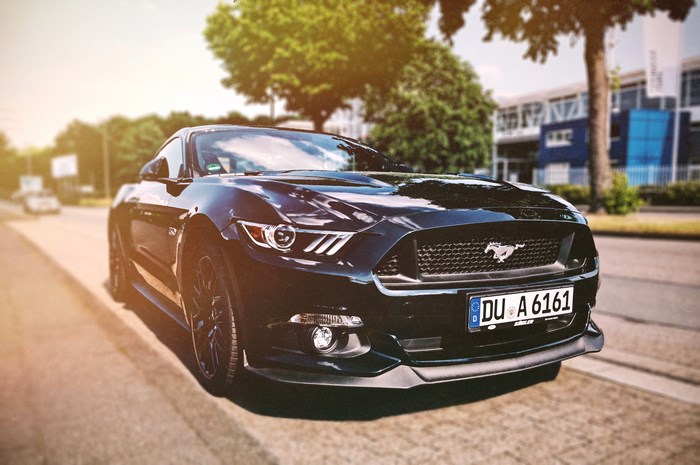 Black Ford Mustang parked on a street