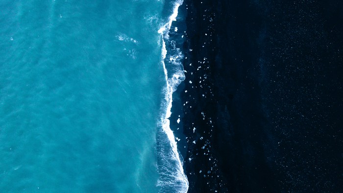 Aerial View of Black Sand Beach and Turquoise Ocean