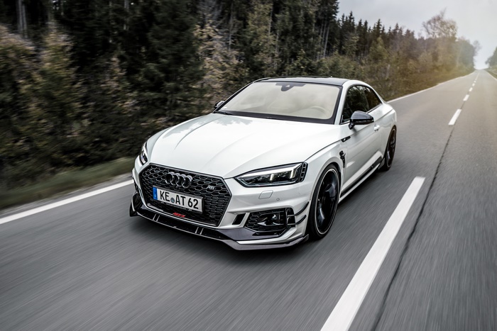 White Audi RS5 Coupe driving on a road