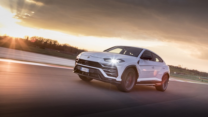 White Lamborghini Urus SUV on a Racetrack at Sunset