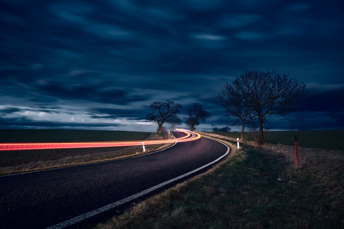 Long exposure of a road with light trails at night