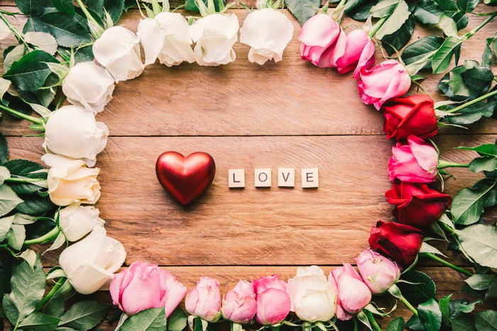 Heart and LOVE spelled with roses and wooden letters