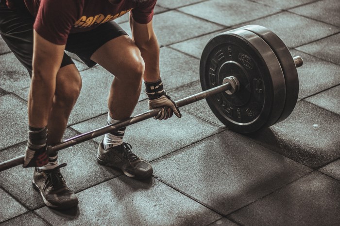 Man Preparing to Deadlift Heavy Weights in Gym