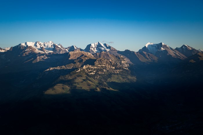 Snow-capped mountains under a clear blue sky in Switzerland
