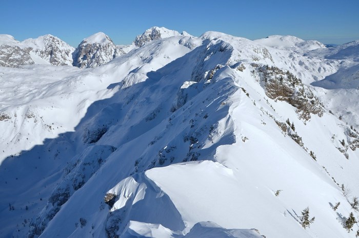 Snowy mountain ridge in Slovenia under a clear blue sky