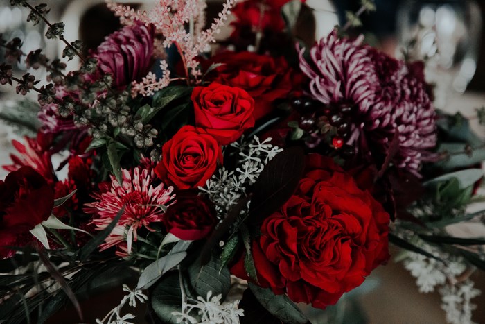 Deep tone bouquet of red roses and purple chrysanthemums