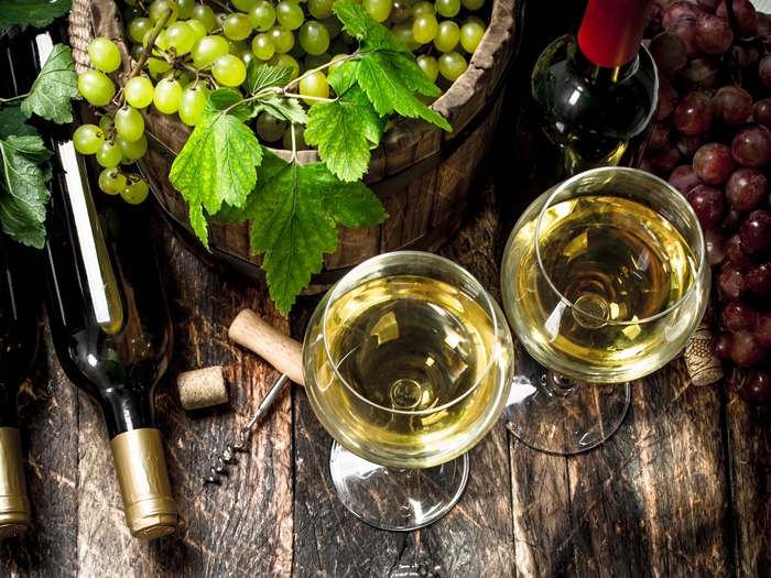 Wine bottles and glasses with grapes
