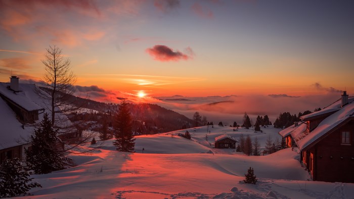 Winter sunrise over Austrian Alps with chalets