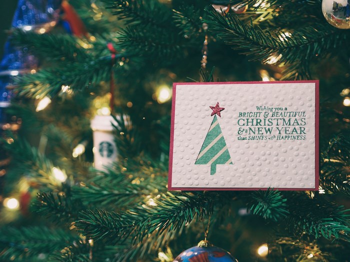 Christmas card on a decorated Christmas tree with lights
