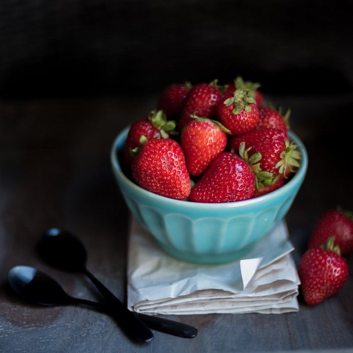 Bowl of fresh strawberries with spoons
