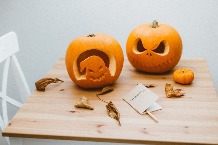 Carved Halloween pumpkins with ghost and evil face