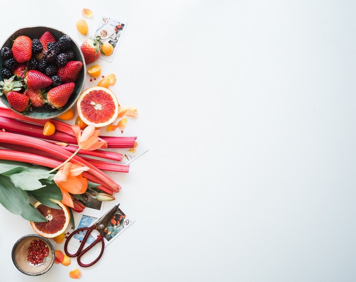 Flat lay of fresh fruits and vegetables with scissors