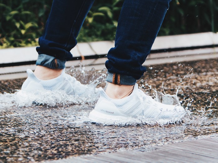 Adidas Ultra Boost sneakers splashing in water