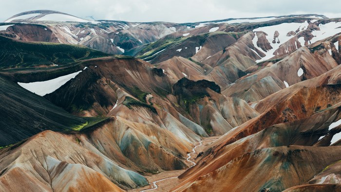 Colorful mountains with snow and a river