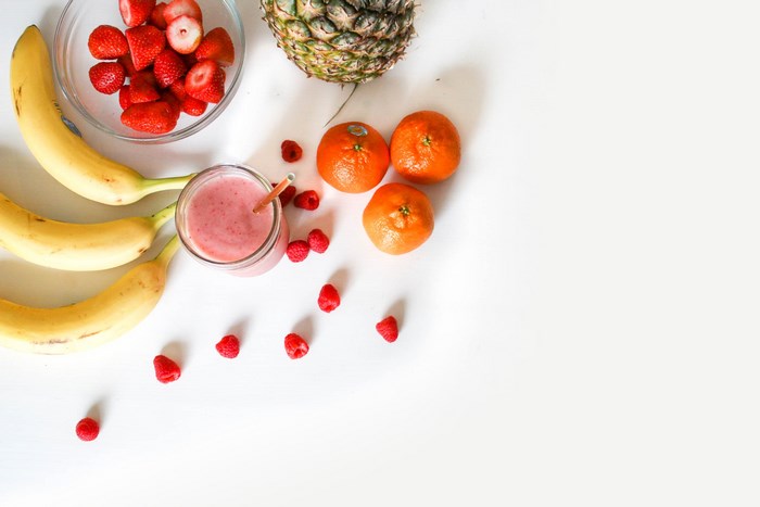 Fruit smoothie with strawberries, bananas, oranges, and pineapple
