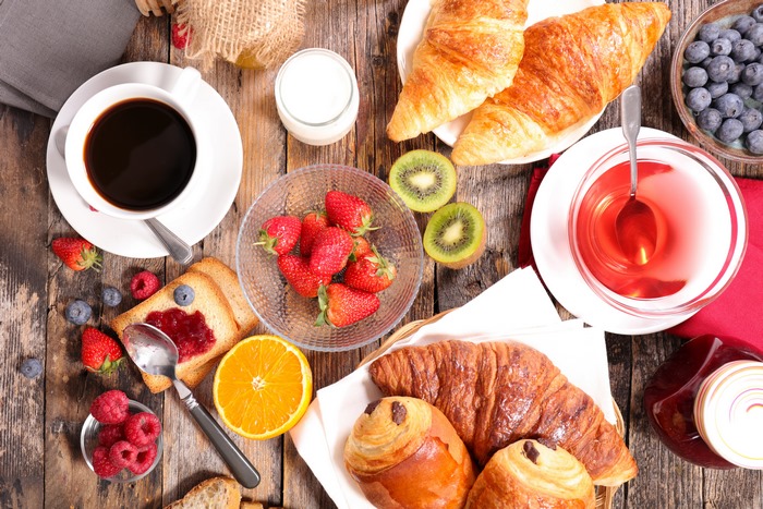Breakfast with coffee, croissants, and fruits