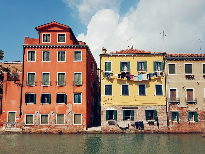 Venice canal with colorful buildings and laundry