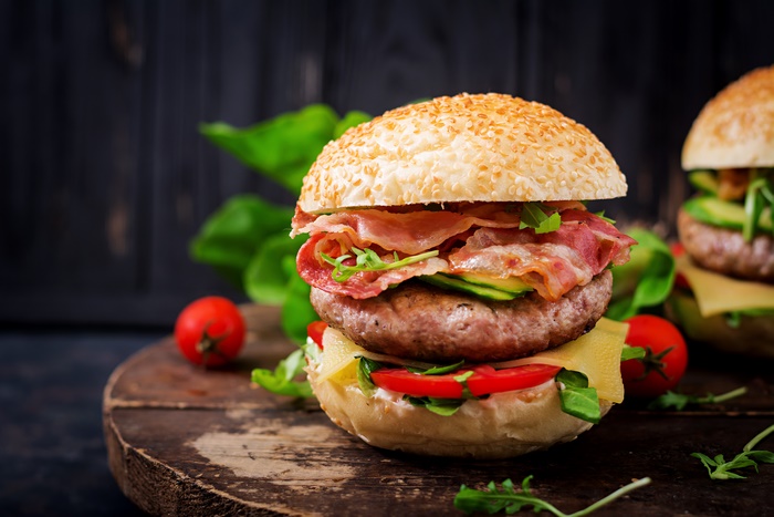 Burger with bacon, cheese, and tomatoes