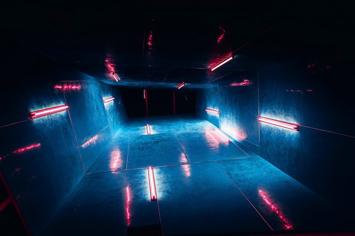 Dark tunnel with blue and red neon lights