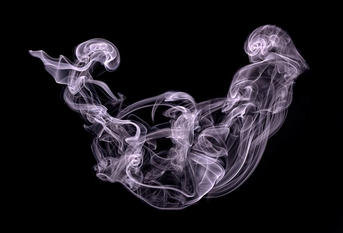 Abstract white smoke against a black background