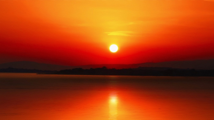 Sunset over a lake with mountains