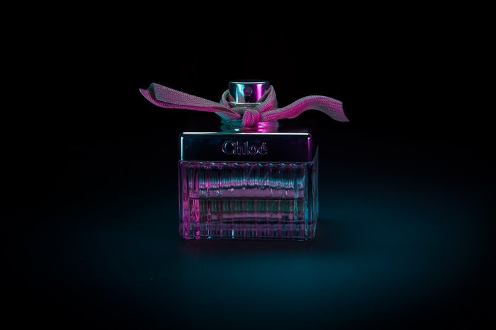 Chloé perfume bottle with pink and blue lighting