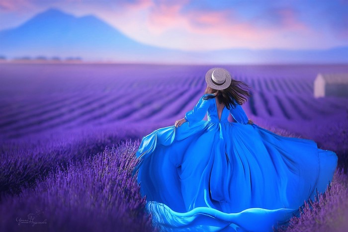 Woman in Blue Dress Wearing Straw Hat in Lavender