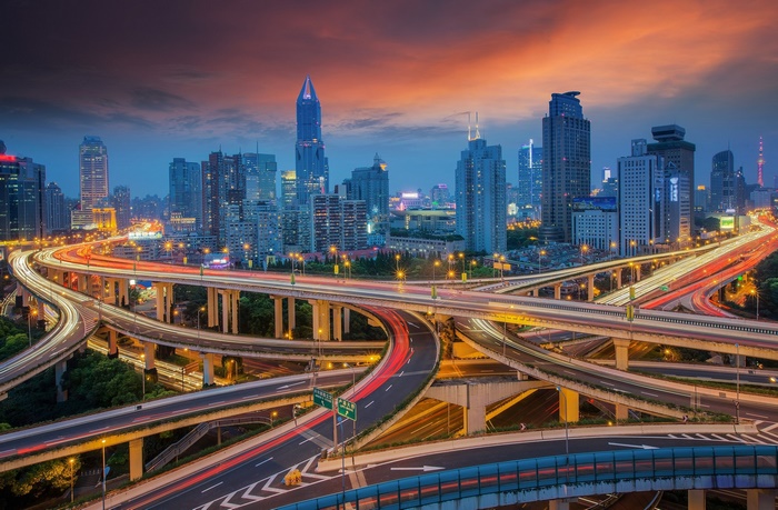Shanghai city skyline with highway interchange at night