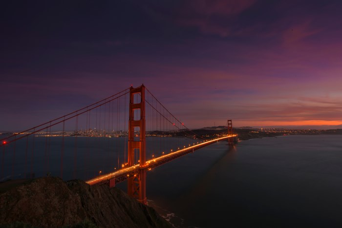 Golden Gate Bridge at sunset with San Francisco skyline