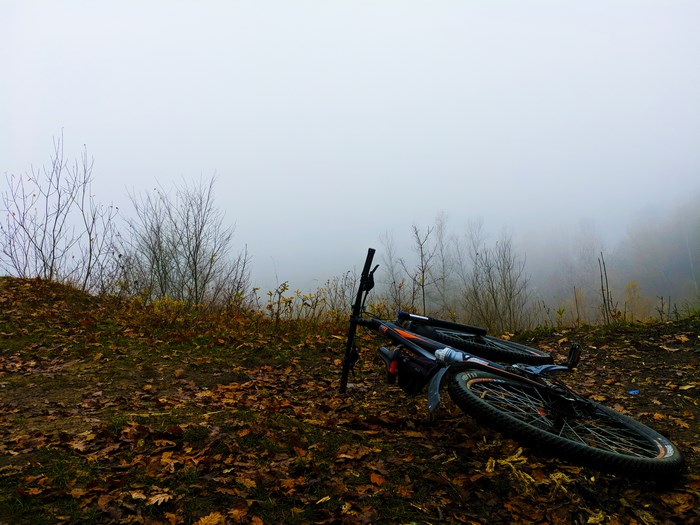 Bicycle lying on the ground in fog