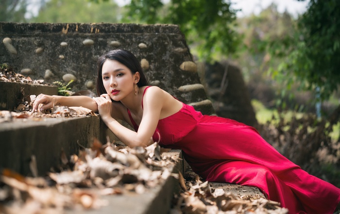 Elegant Asian Woman in Red Dress Outdoors