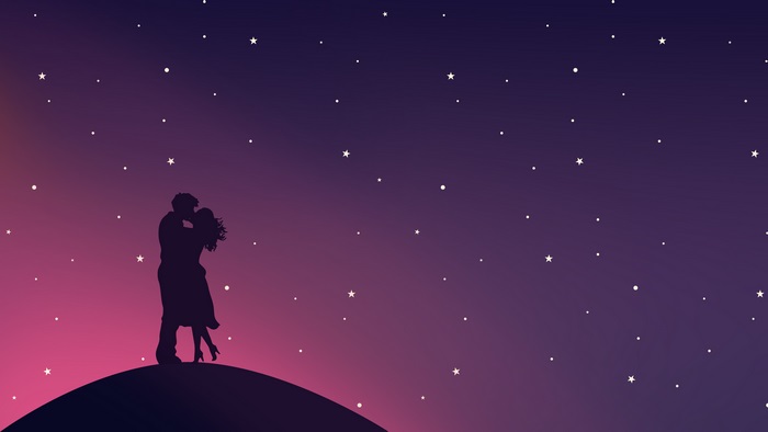 Couple kissing on a hill under a starry sky