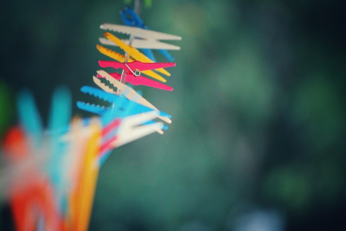 Colorful clothespins hanging on a line outdoors