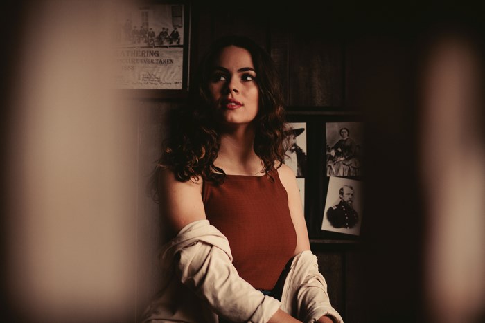 Woman in a room with historical photos