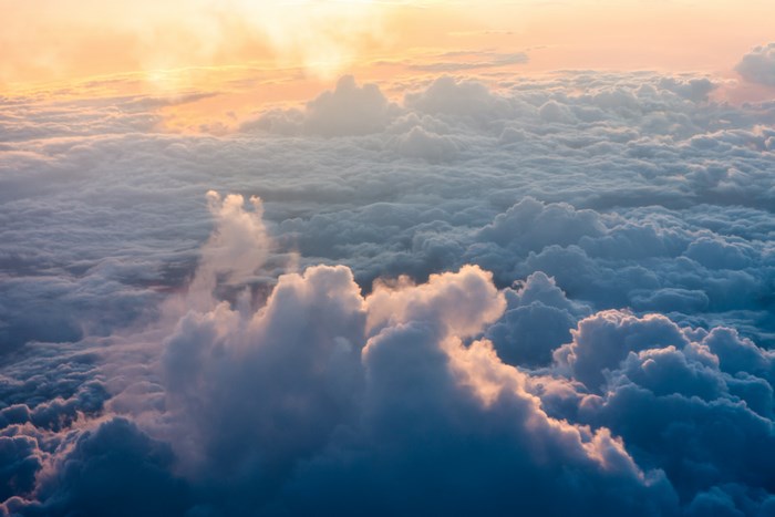 View of clouds from airplane during sunset