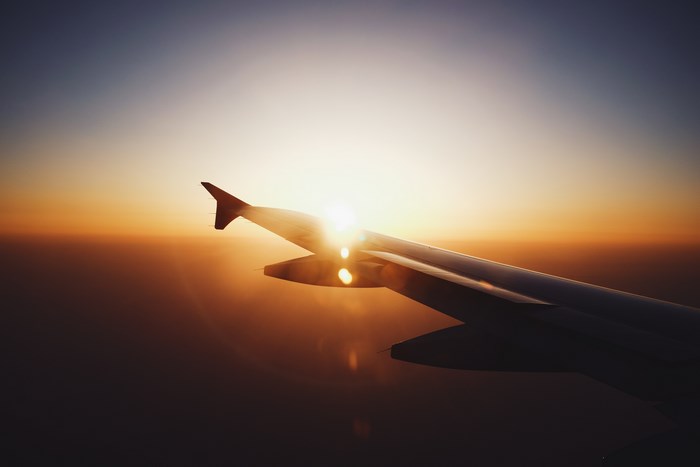 Airplane wing during sunset flight