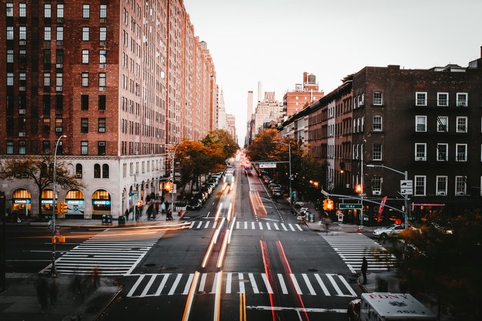 New York City street with light trails and buildings