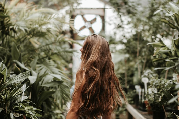 Woman in a greenhouse with plants