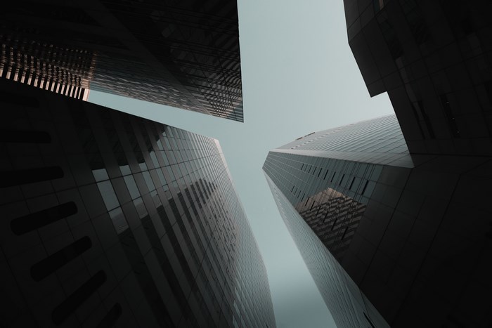 Looking up at skyscrapers from below