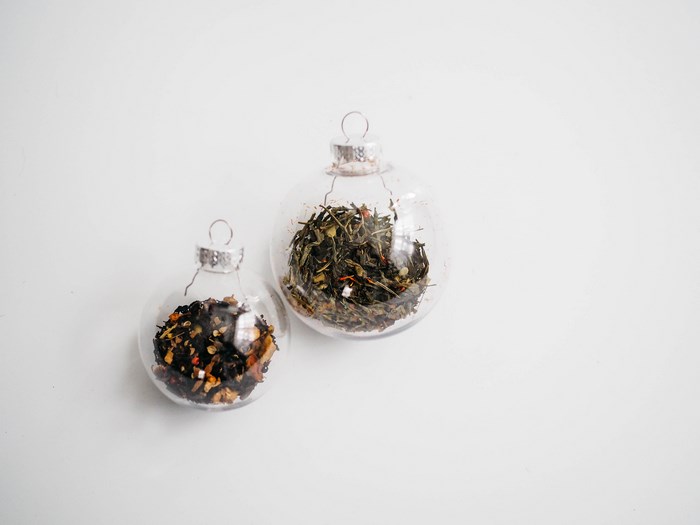 Two clear ornaments filled with loose leaf tea