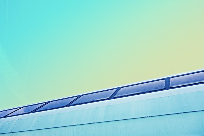 Abstract gradient sky over modern building windows