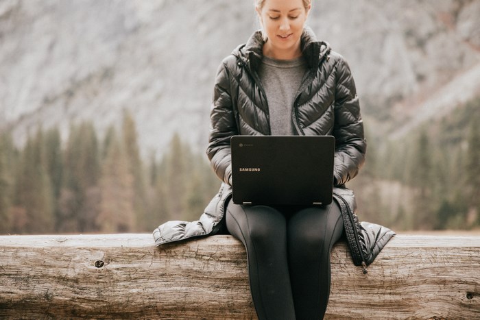 Woman using Samsung Chromebook outdoors