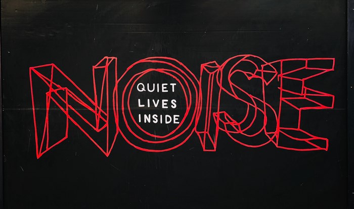 Red outline text NOISE with "QUIET LIVES INSIDE" in the center